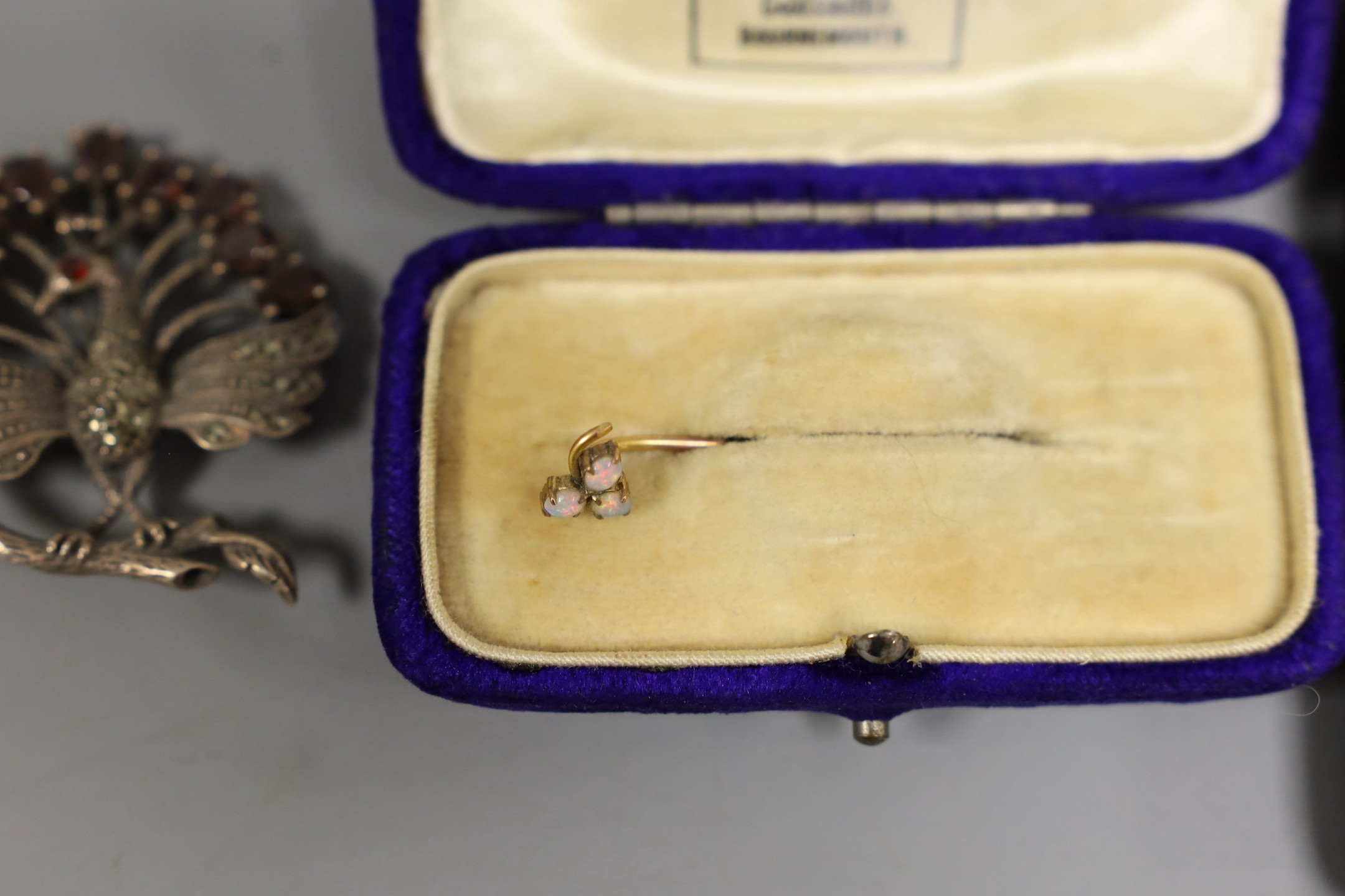 Minor jewellery including a marcasite set peacock brooch, a yellow metal and three stone white opal set stick pin, etc.